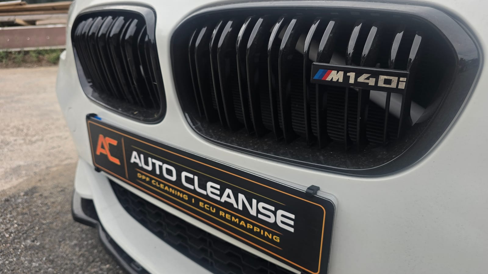 A white BMW M140i with a gloss black kidney grille and an Auto-Cleanse number plate surround, Stage 1 remapped by Auto-Cleanse in Devon